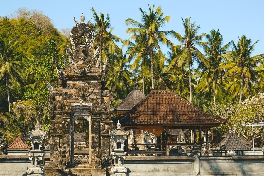 Palmeras y templo hindú balinés en Crystal Bay en Nusa Penida, Bali